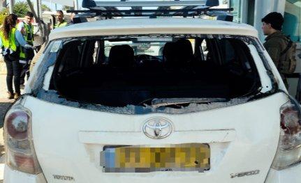 The family's vehicle with a shattered rear windshield, photographed at a checkpoint after the escape